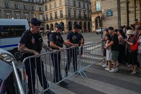 Paris Olympics: French police set up barricades to close the road outside the Tuileries garden as the cauldron is extinguished